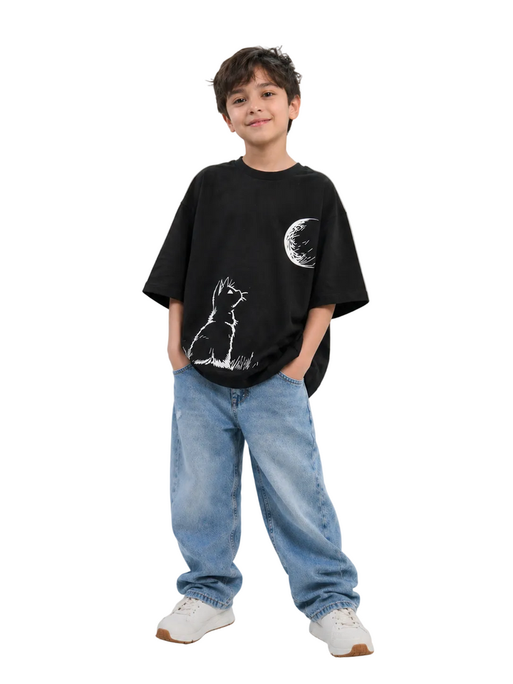 Child wearing a black t-shirt with a graphic design and blue jeans on a white background