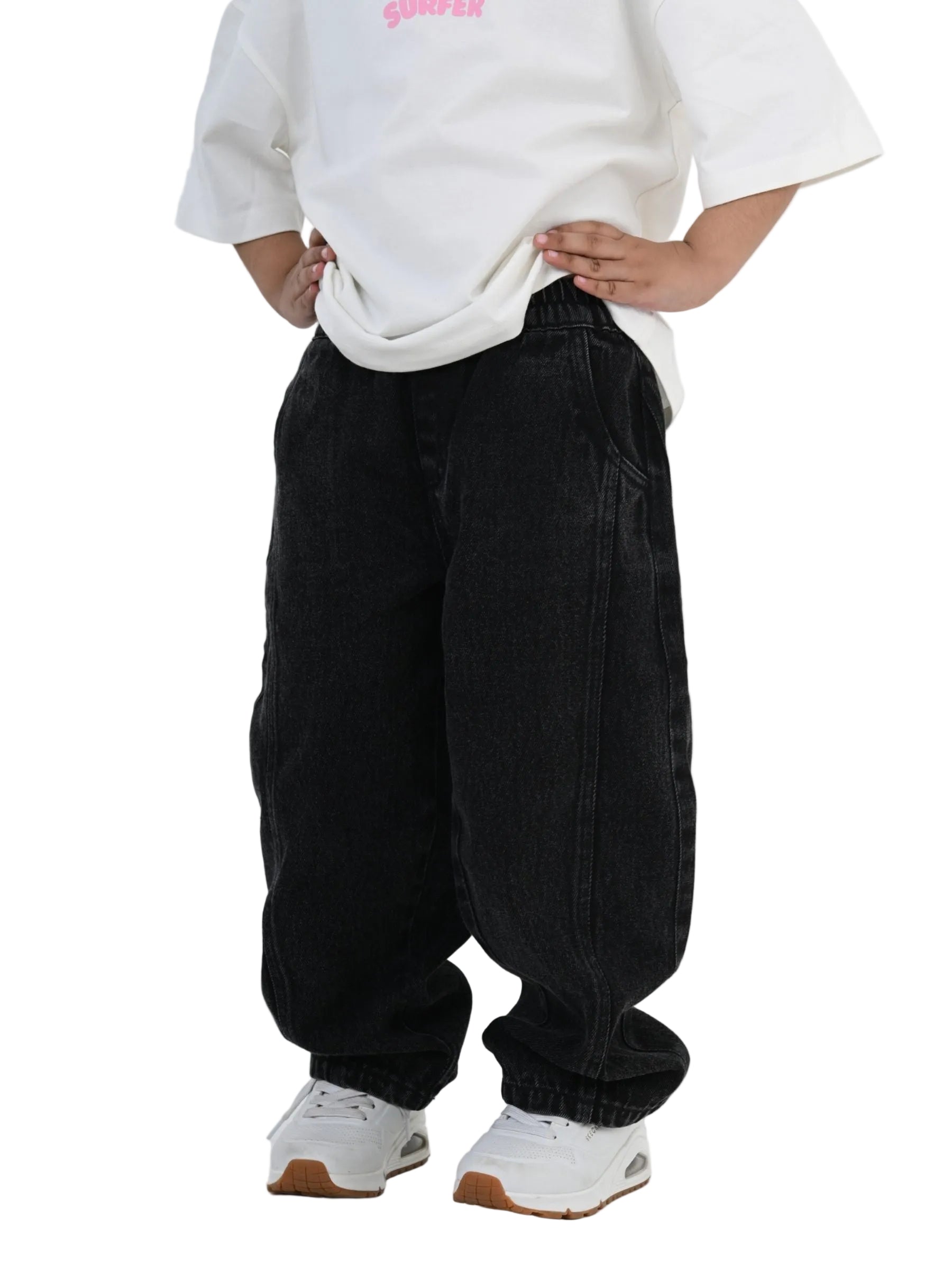 Person wearing a white oversized sweatshirt and black baggy pants on a white background
