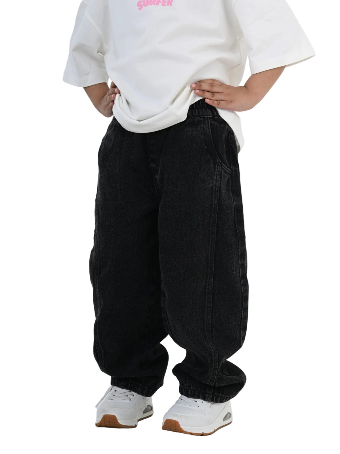 Person wearing a white oversized sweatshirt and black baggy pants on a white background
